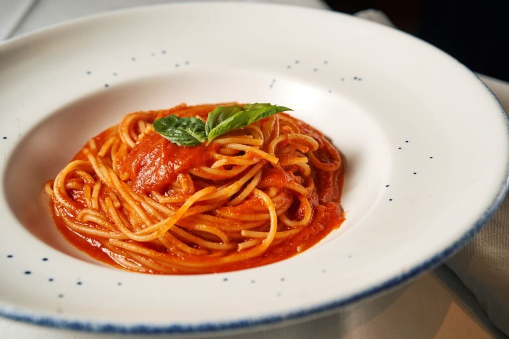 Classic Italian spaghetti in rich tomato sauce garnished with basil.